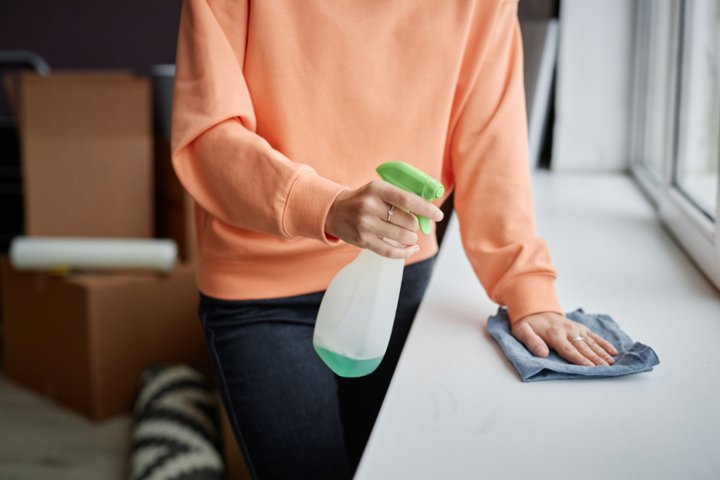 Homeowner wiping down a surface with cleaner promoting everyday cleanliness.
