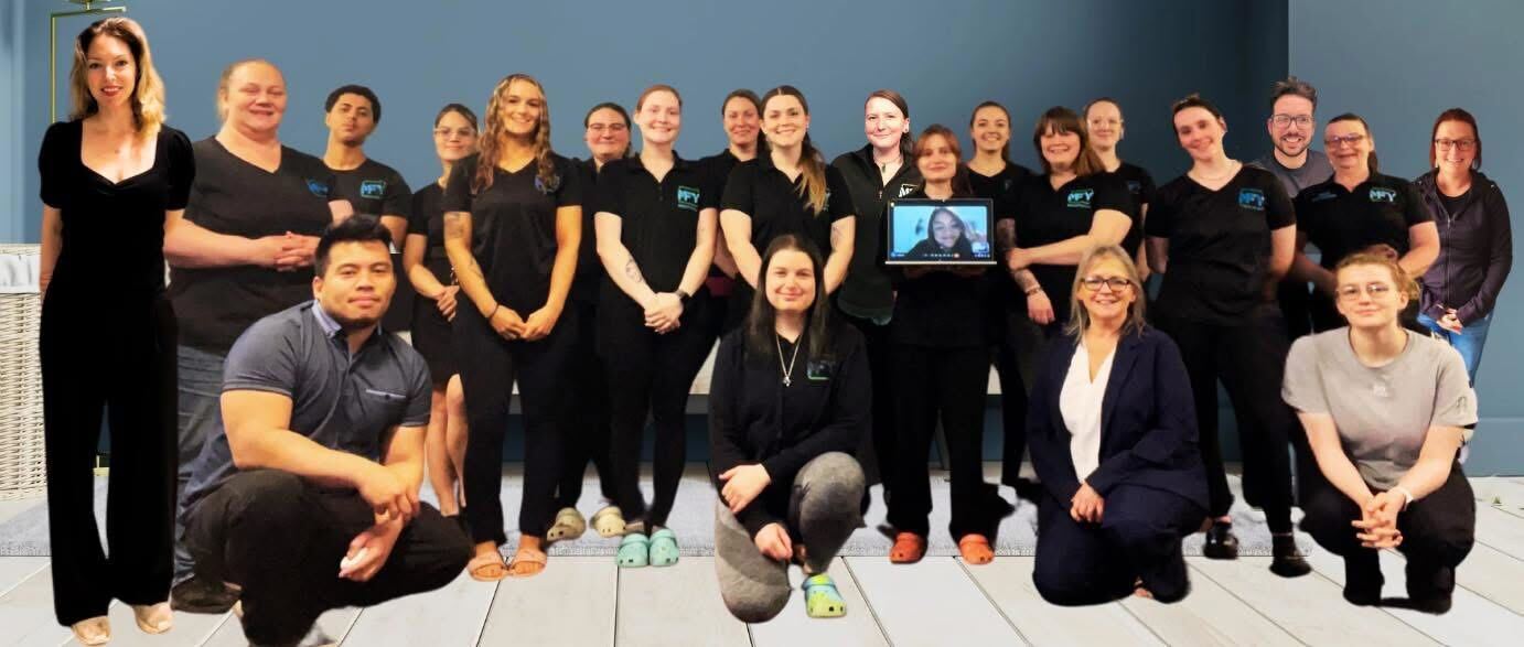 Group photo of the Maid For You NH team, smiling and gathered together for a group photo