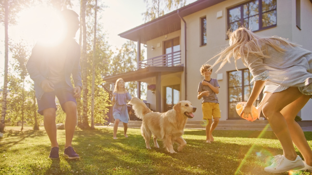 Parents and children enjoying time outdoors with their dog after residential maid service.